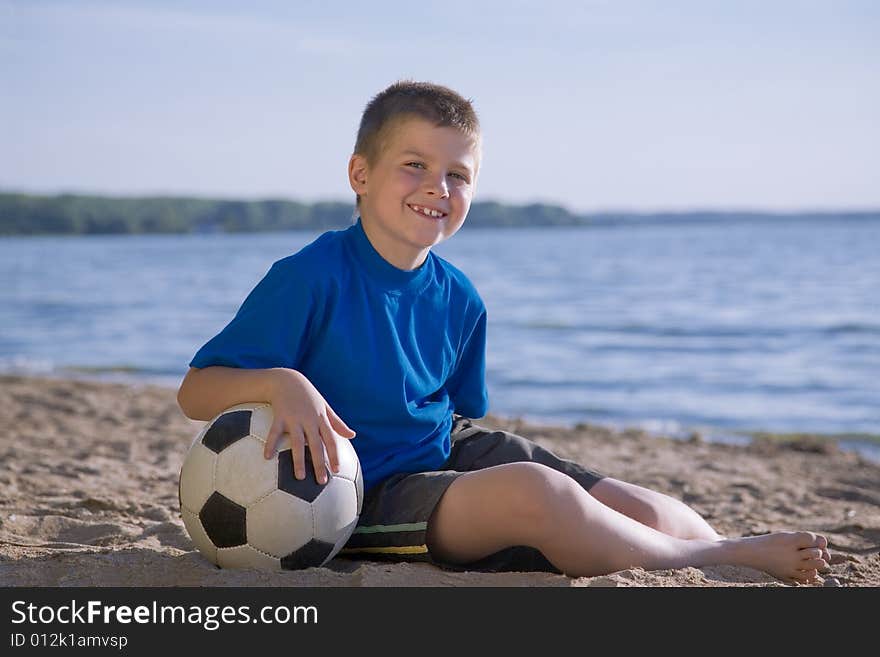 Boy playing with ball on the beach