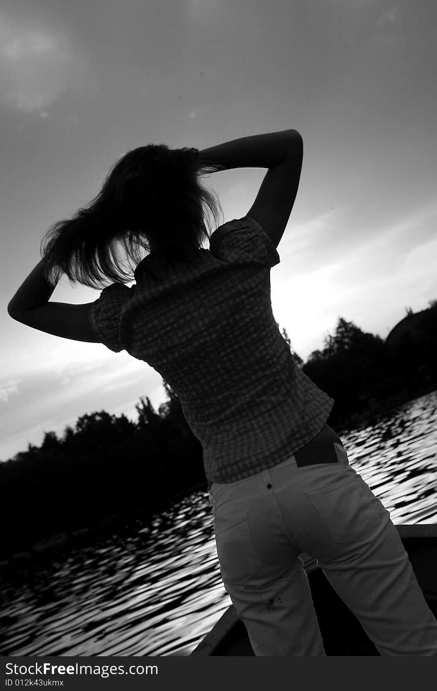 Silhouette of a girl on the lake