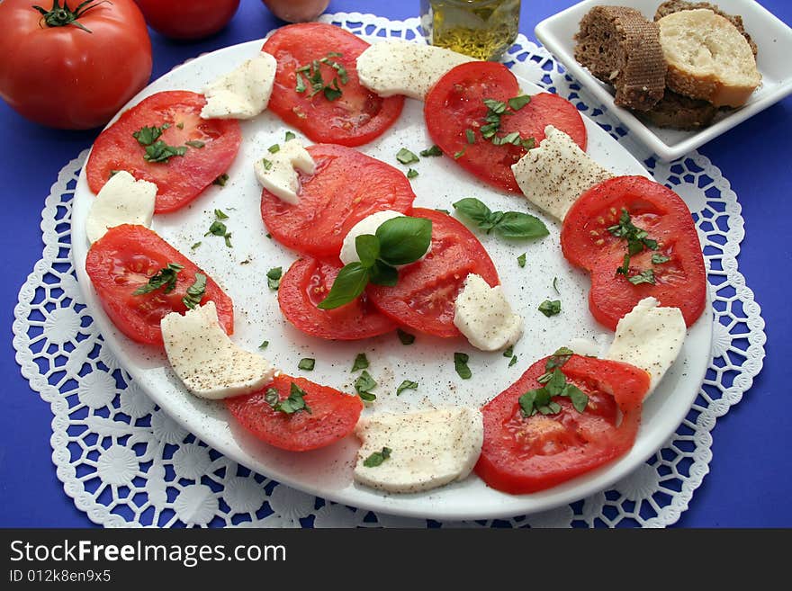 Some cheese and tomatoes on a plate