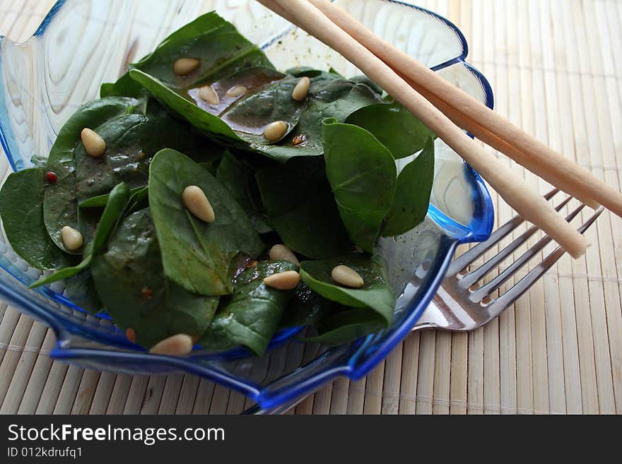 A salad of frech spinach with pine corns