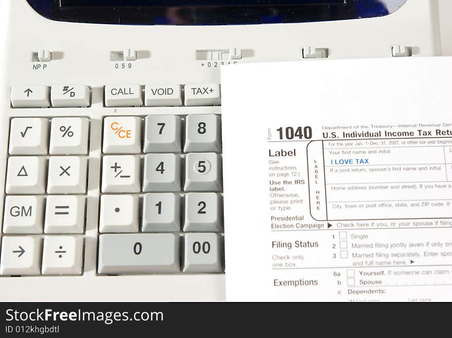 An image of tax return with a calculator to make the account. An image of tax return with a calculator to make the account