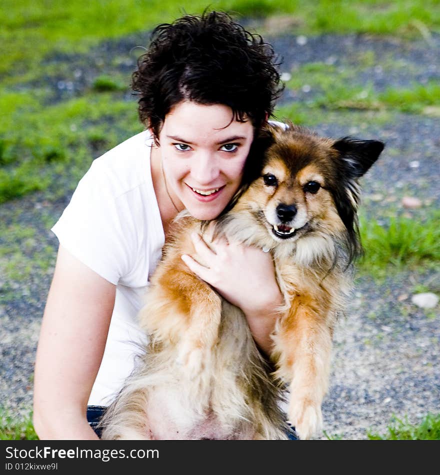 A woman cuddling her cute dog. A woman cuddling her cute dog