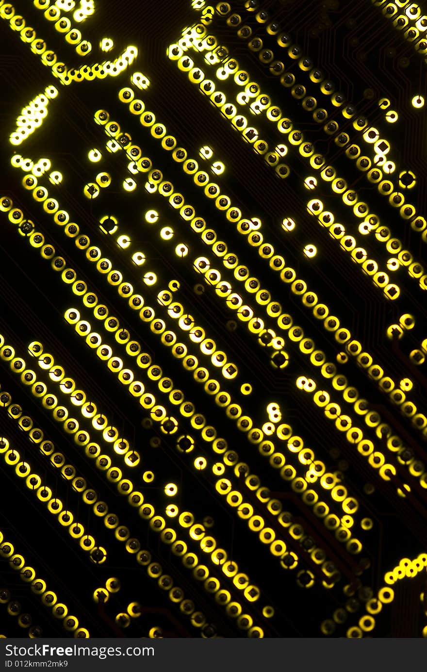 Yellow circuit board closeup lit from below through the board, creating a unique glow effect. Yellow circuit board closeup lit from below through the board, creating a unique glow effect.