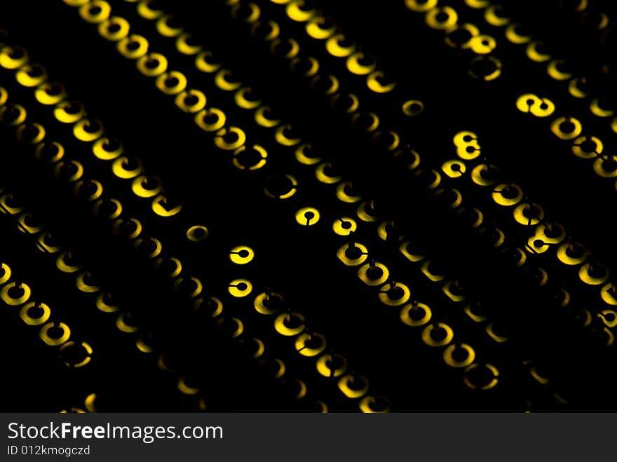 Yellow circuit board closeup lit from below through the board, creating a unique glow effect. Yellow circuit board closeup lit from below through the board, creating a unique glow effect.