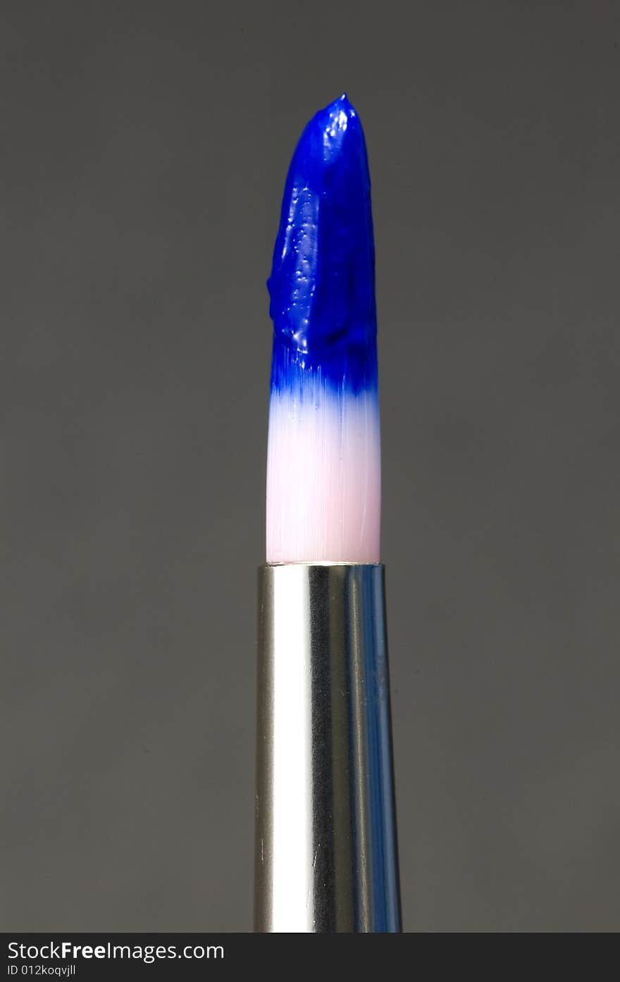 Loaded paint brush with acrylic blue paint