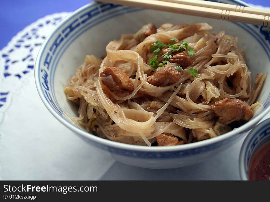 Chinese food with noodles and meat in chinese table-ware