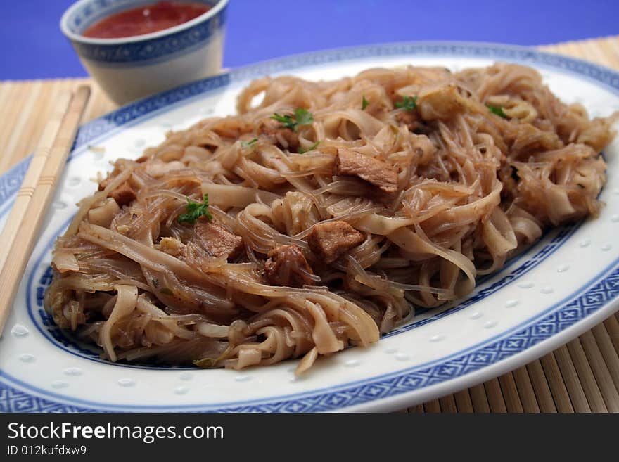 A chinese meal with mie noodles and meat. A chinese meal with mie noodles and meat