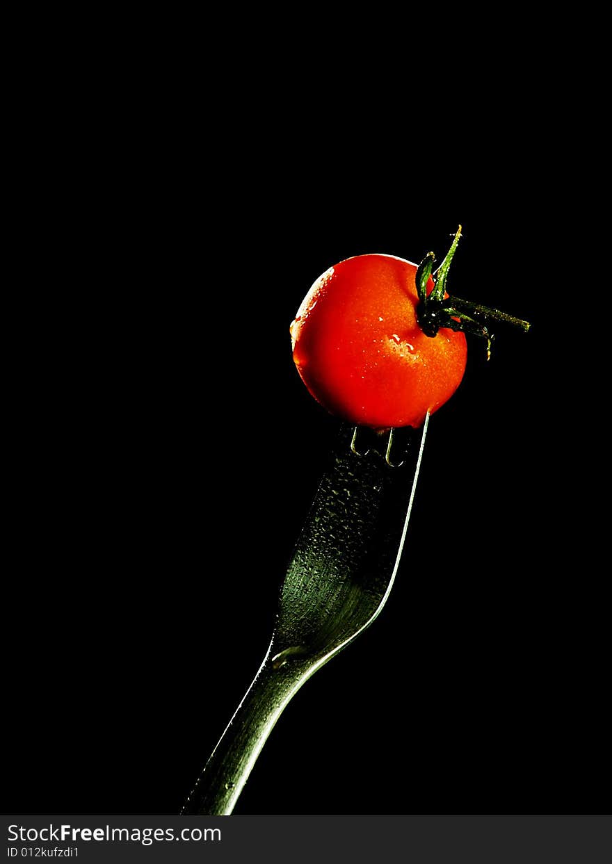 Cherry tomato on a silver fork