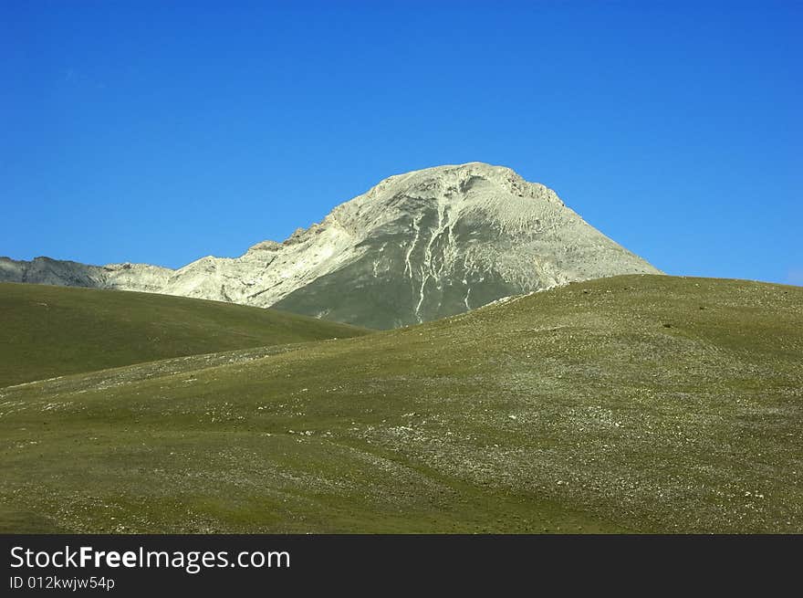 Magnificent view of a mountain with blue sky in the background.