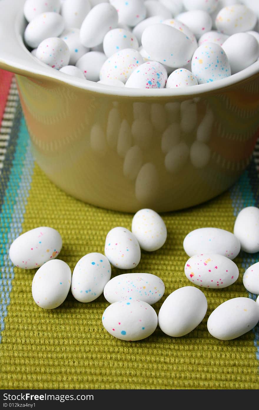 Miniature speckled easter eggs in a green bowl