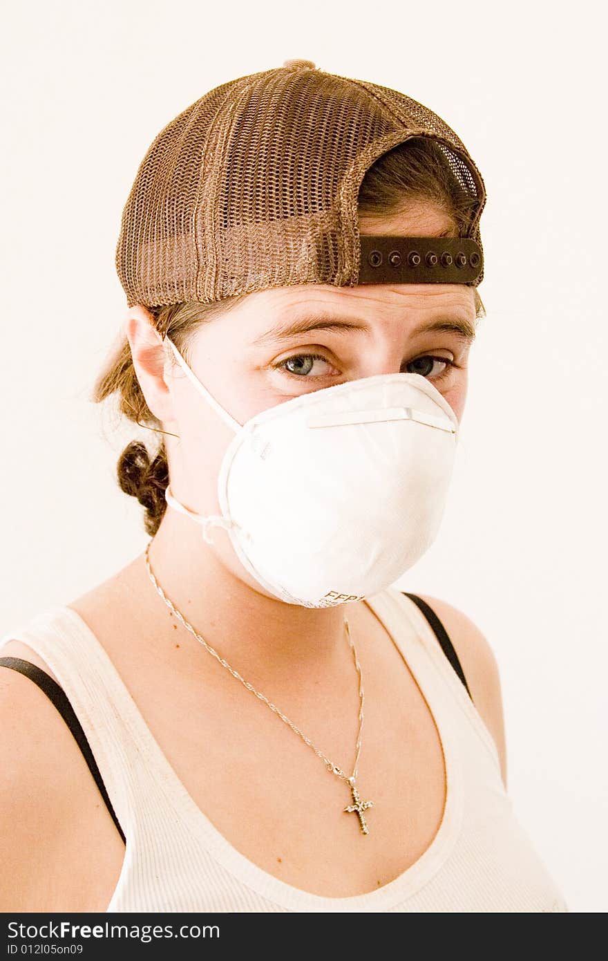 Woman renovating kitchen cupboard wearing a mask. Woman renovating kitchen cupboard wearing a mask