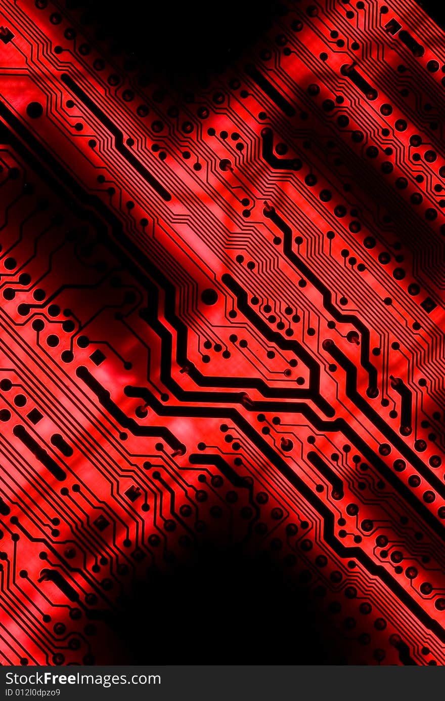 Red circuit board closeup lit from below through the board, creating a unique glow effect. Red circuit board closeup lit from below through the board, creating a unique glow effect.