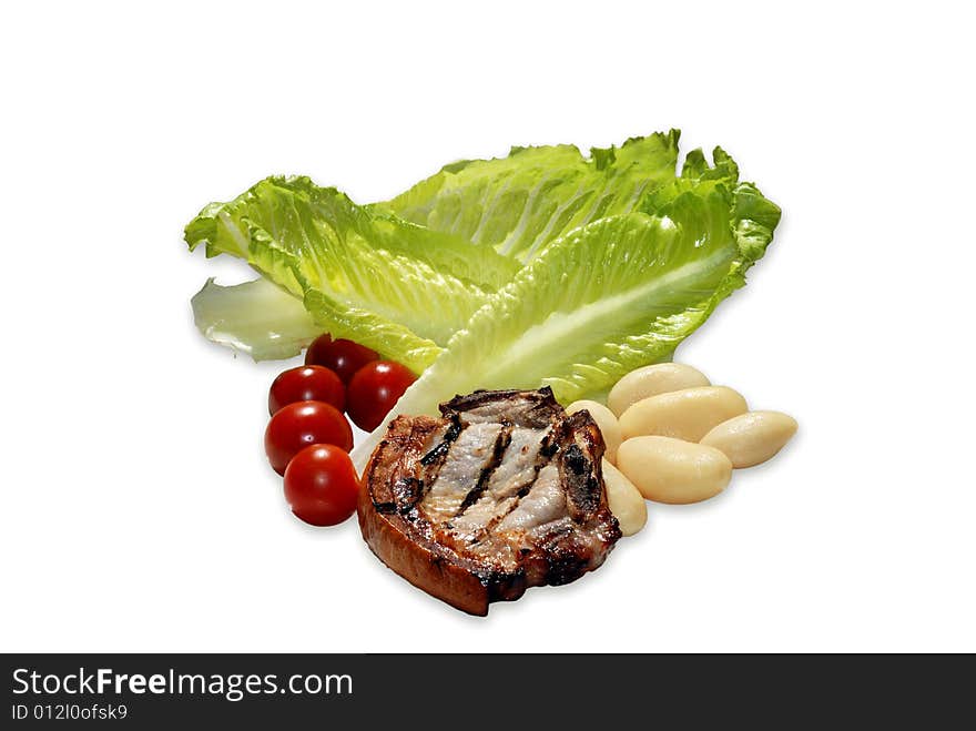 Grilled pork chop and salad with dark cherry tomatoes, potatoes and lettuce on a white background.