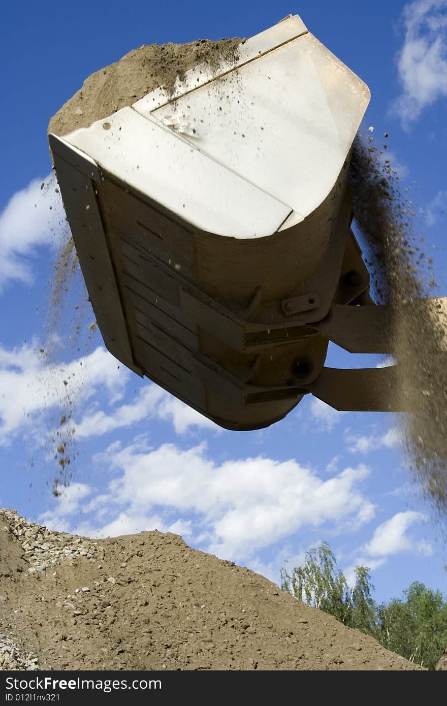 Loading earth in quarry background sky. Loading earth in quarry background sky