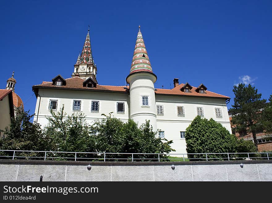 A house and a tower of church in background in Marija Bistrica, Croatia. A house and a tower of church in background in Marija Bistrica, Croatia.