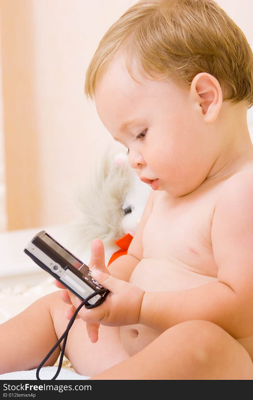 Cute little child playing with compact digital camera. Cute little child playing with compact digital camera