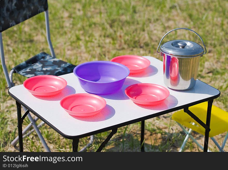 Picnic table with plates, situated on the ground