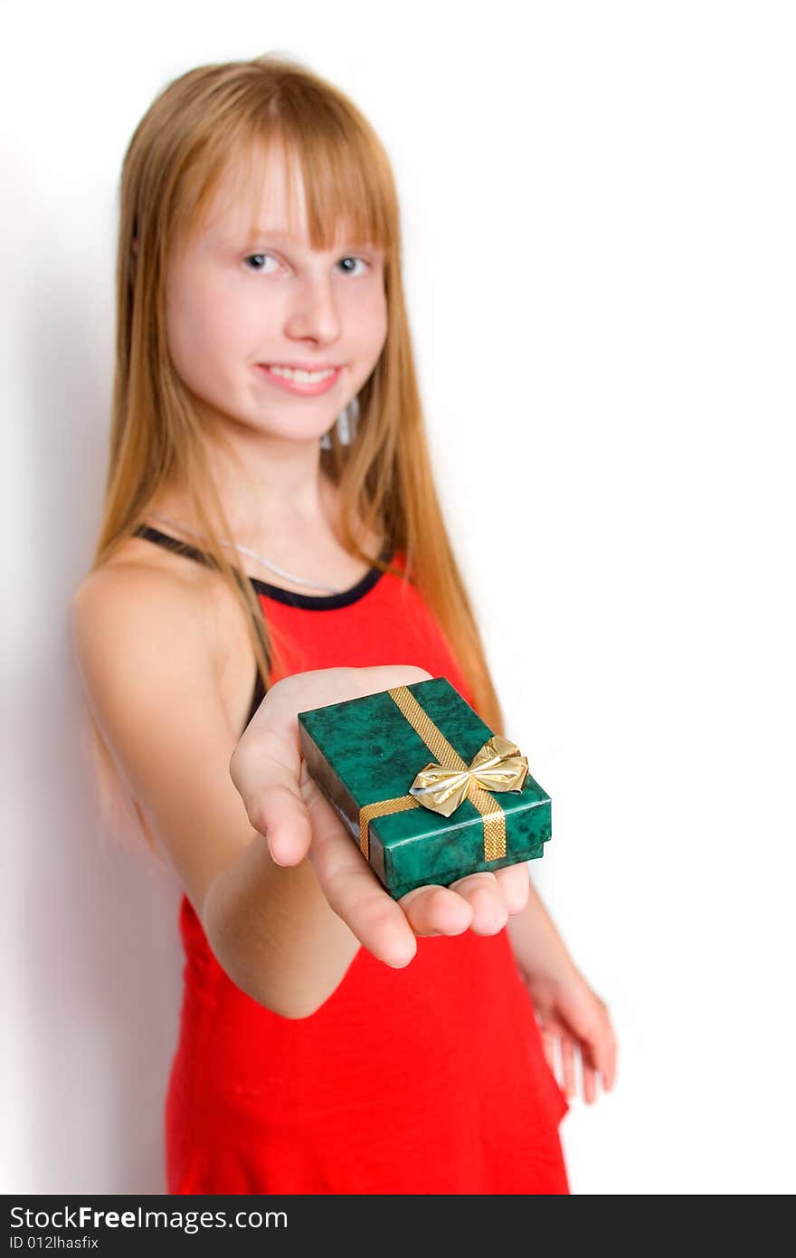 Pretty teenager girl in red dress holding gift box