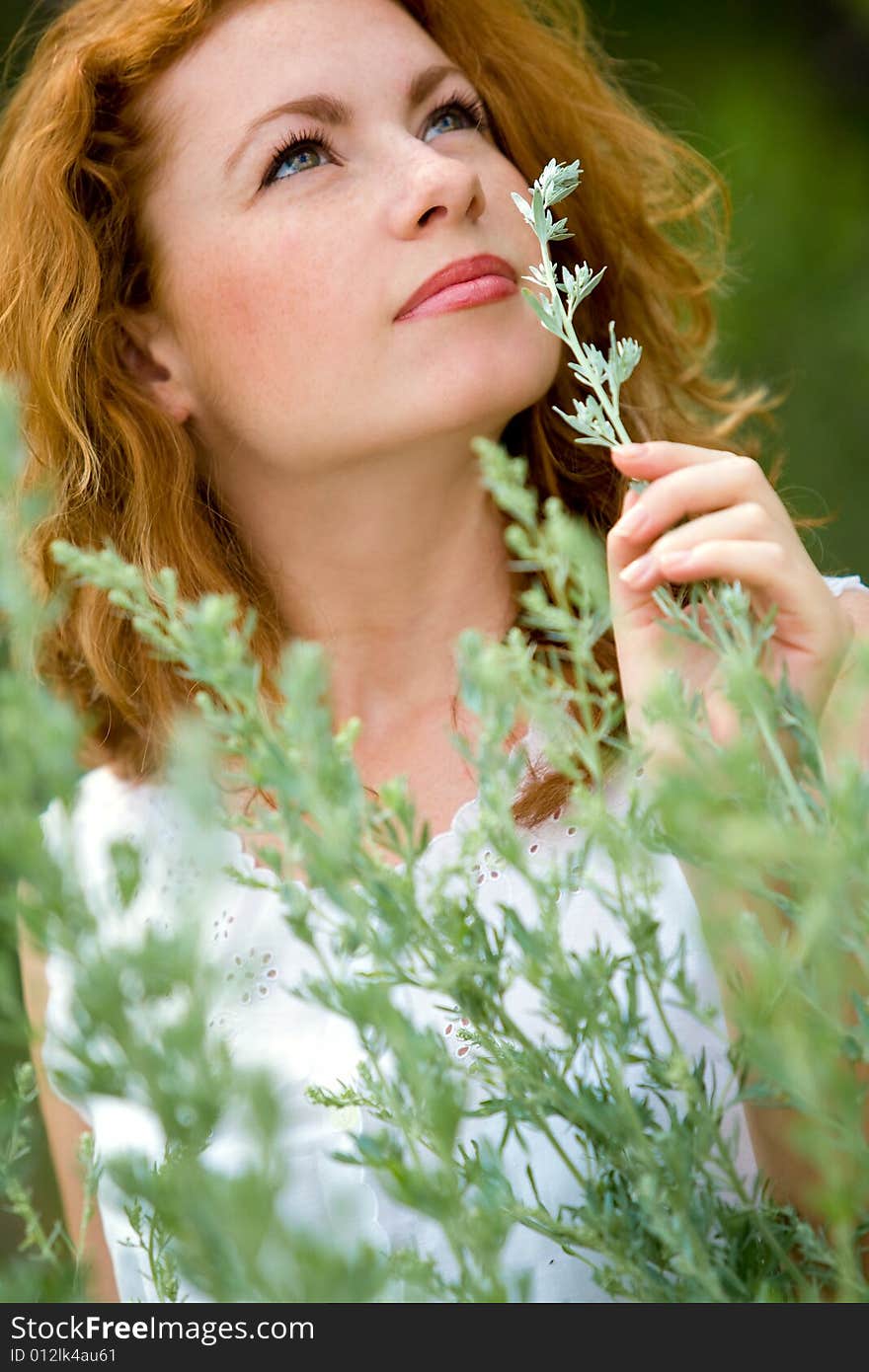 Beautiful red-haired girl outdoor portrait