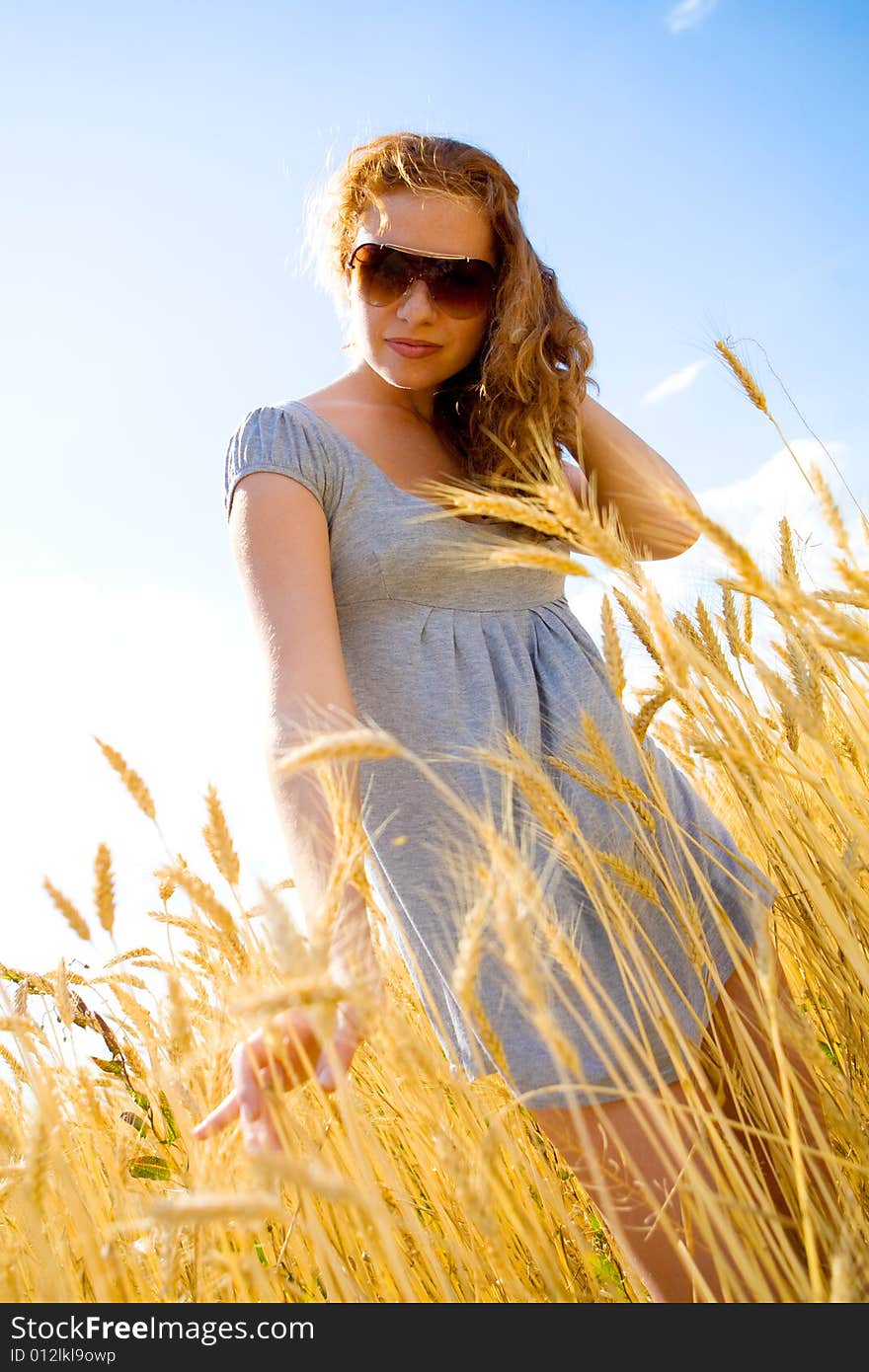 Beautiful woman in wheat field at sunny day. Beautiful woman in wheat field at sunny day