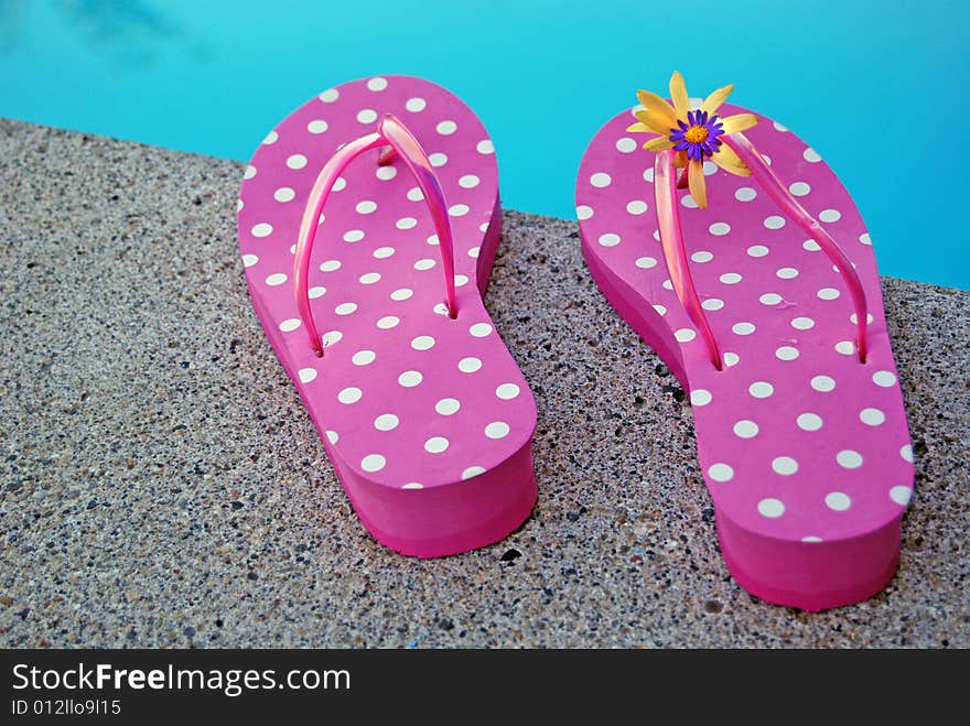 Pair of summer shoes at poolside. Pair of summer shoes at poolside.