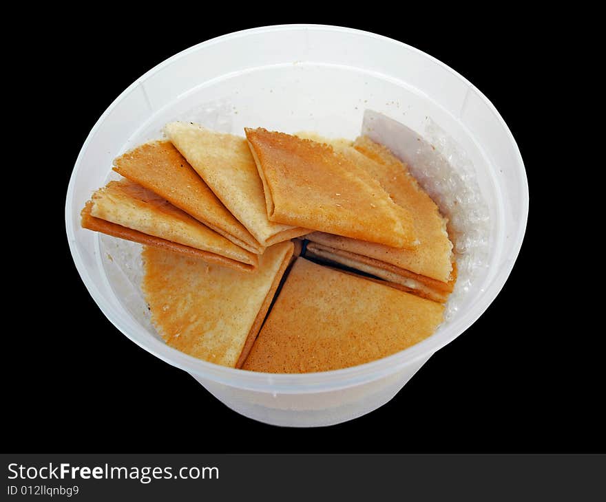 Asian flat & thin Cookies in white plastic Container perspective view. Asian flat & thin Cookies in white plastic Container perspective view