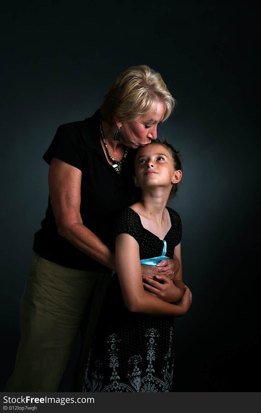 Grandmother kissing granddaughter