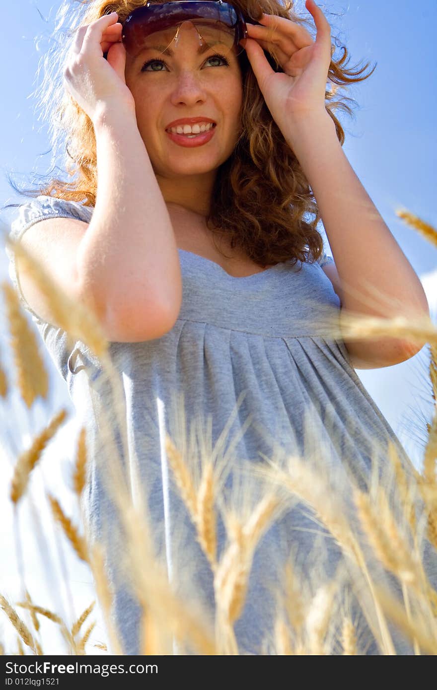 Beautiful woman in wheat field at sunny day. Beautiful woman in wheat field at sunny day