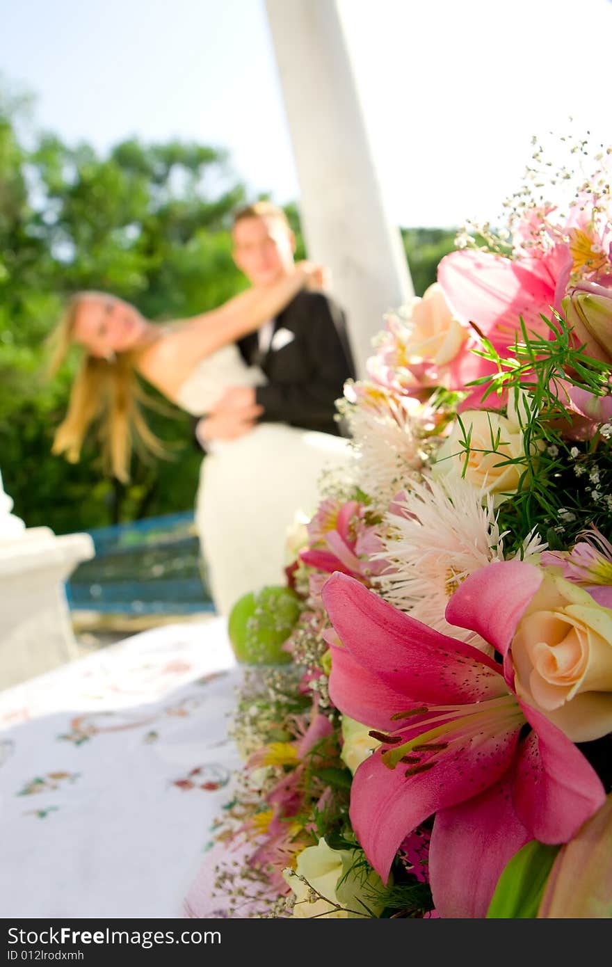 Colorful wedding shot of bride and groom with flowers on front. Colorful wedding shot of bride and groom with flowers on front