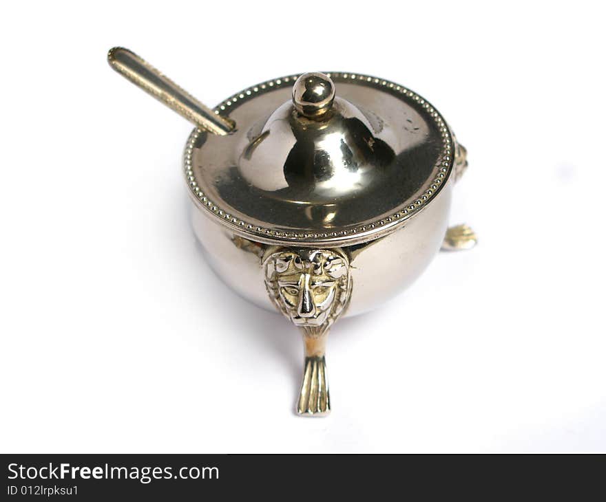 Chromed sugar basin and tea spoon on a white background