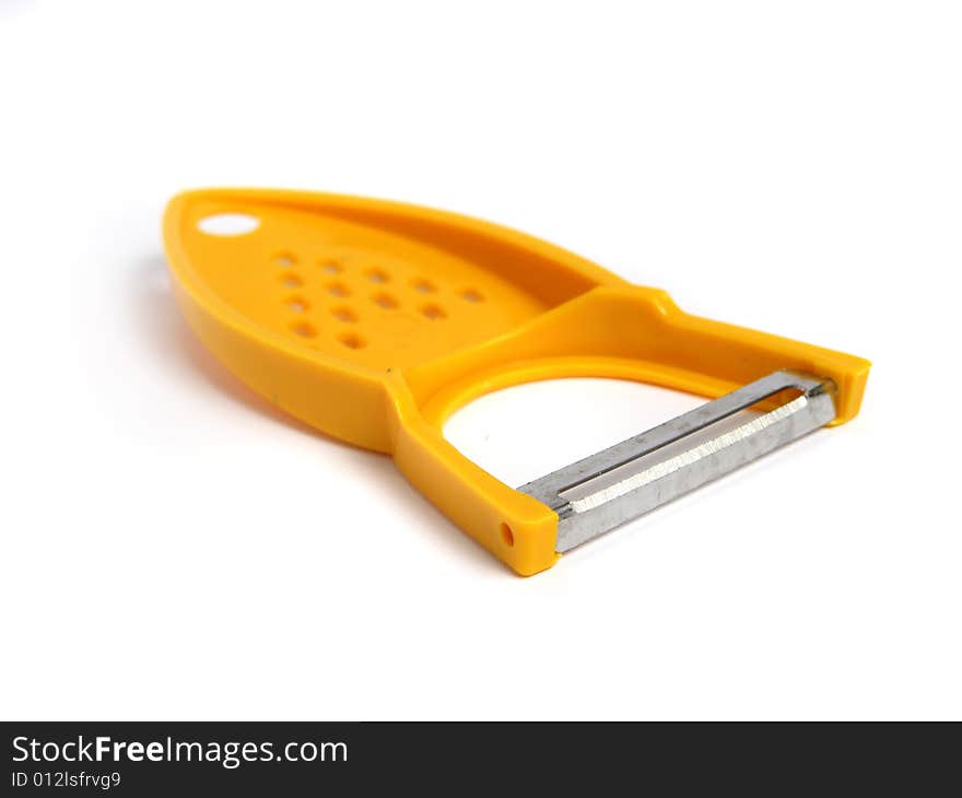 Yellow potato peeler and grater on white background