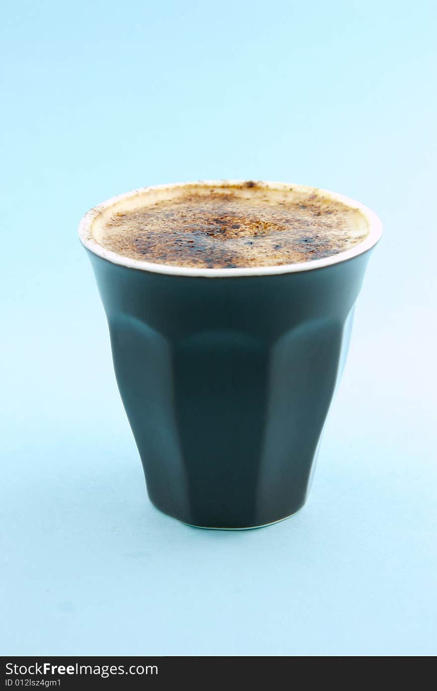 Cappuccino isolated against a blue background