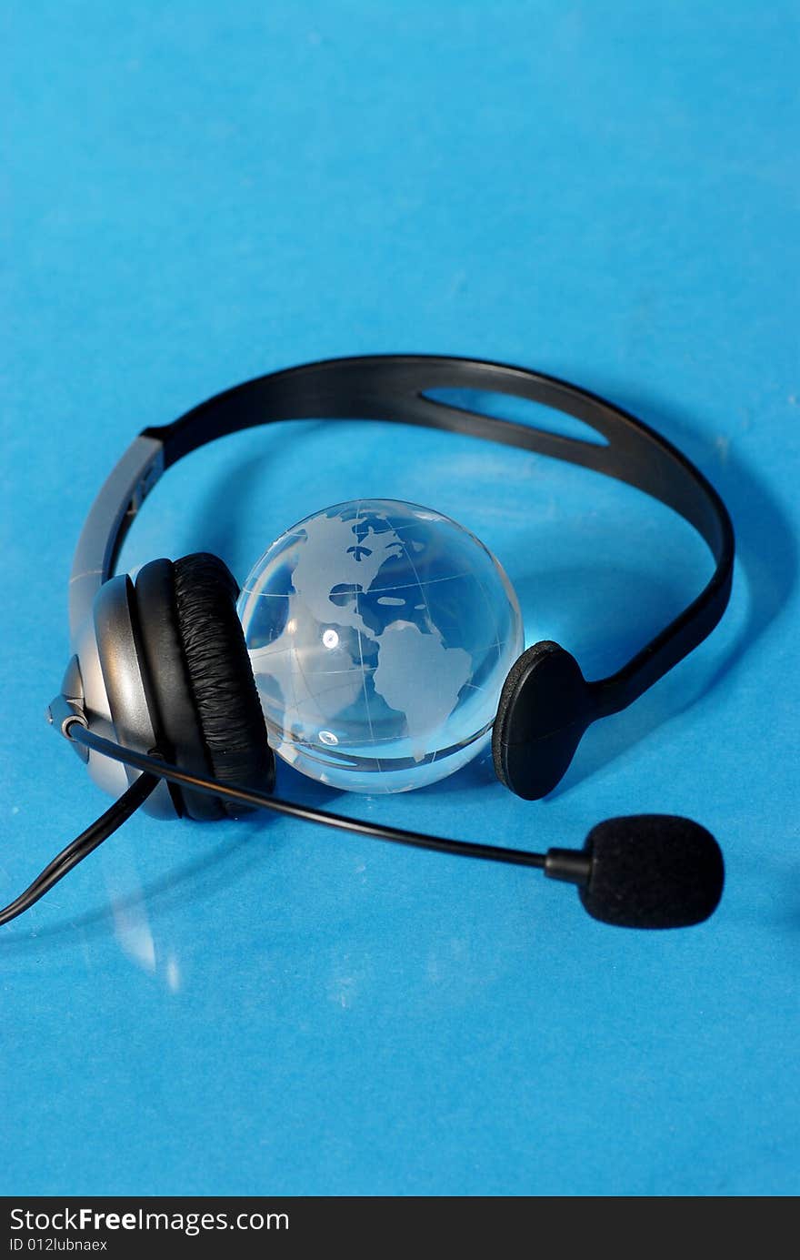 Globe and headphone isolated on blue background. Globe and headphone isolated on blue background