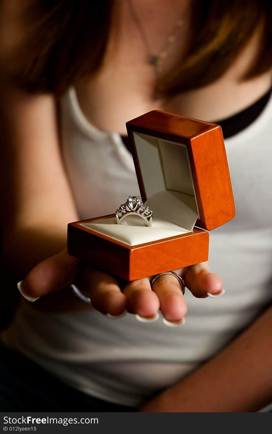 A gorgeous white gold diamond engagement ring presented in a warm wooden box. A gorgeous white gold diamond engagement ring presented in a warm wooden box.