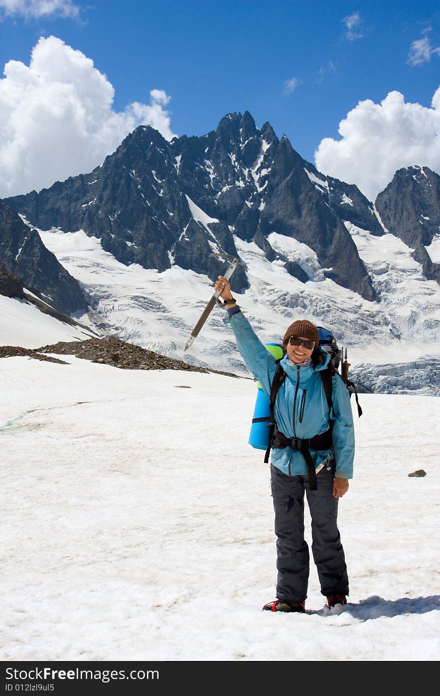 Smiling girl with ice-axe on glacier at Caucasus mountains. Smiling girl with ice-axe on glacier at Caucasus mountains