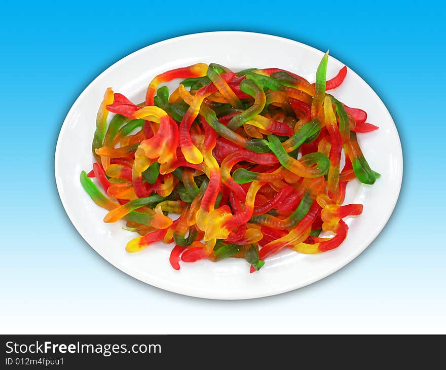 A plate of colorful worm shaped jelly candies. Including clipping path.