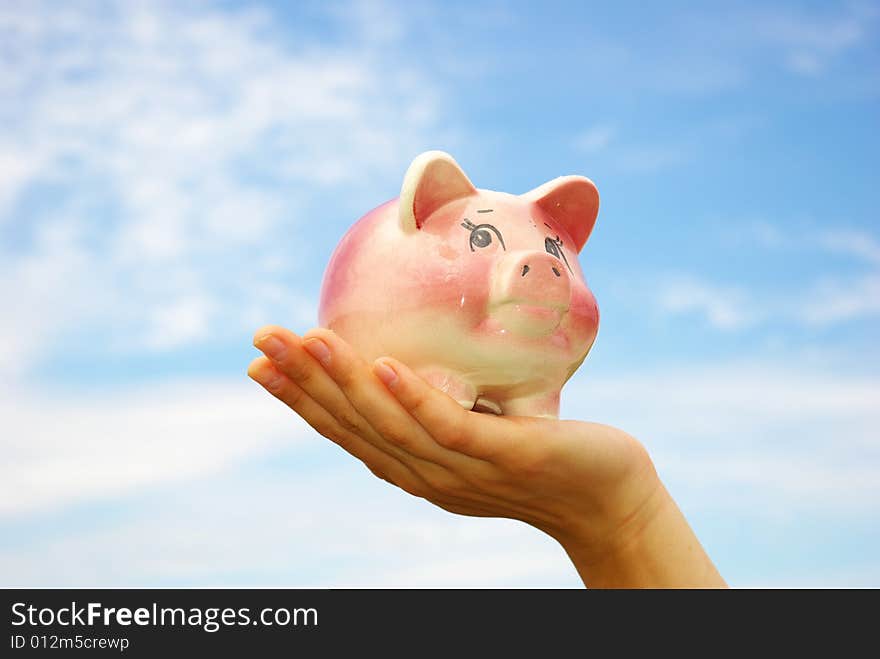 Saving money  woman hands holding piggy bank. Saving money  woman hands holding piggy bank