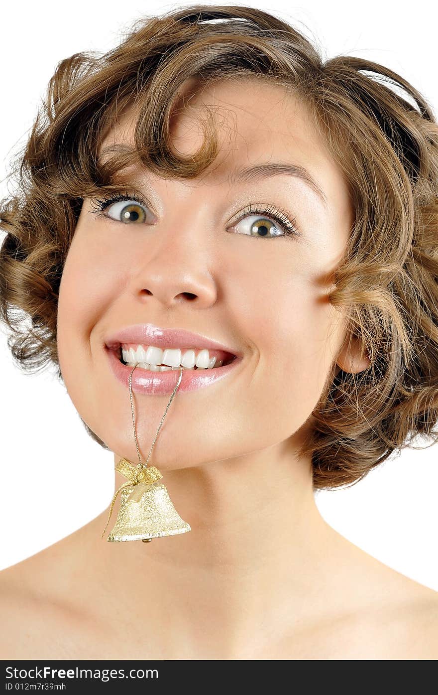 Cheerful young girl with a small bell in mouth