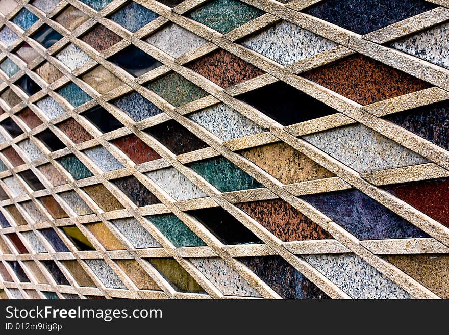 Creative tile arrangement on a wall where the color and texture interplay is focused within by rules of linear geometry. Creative tile arrangement on a wall where the color and texture interplay is focused within by rules of linear geometry.