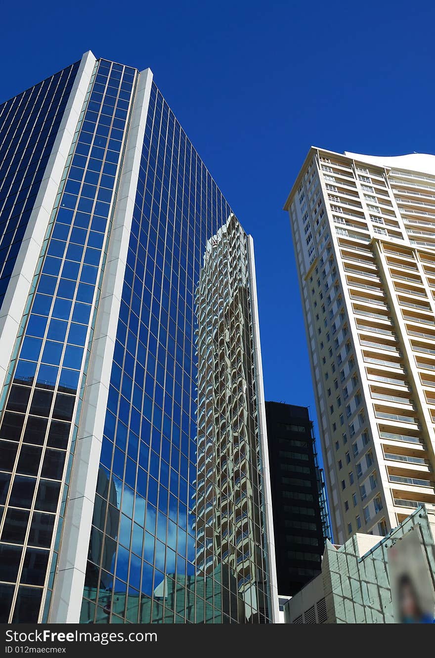 Modern building reflection on a background of blue sky
