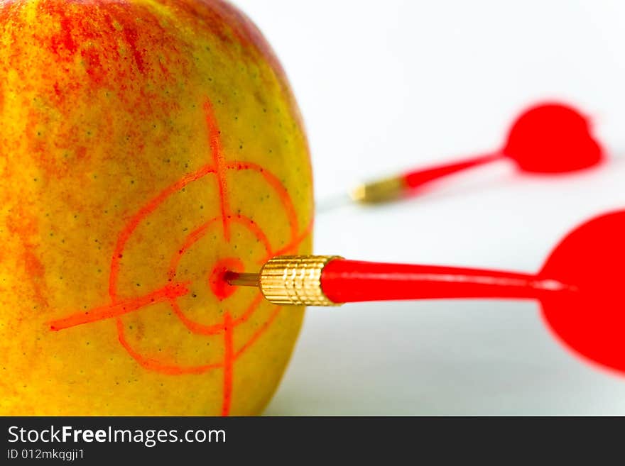 Red-yellow Apple with Darts closeup on White Background. Red-yellow Apple with Darts closeup on White Background