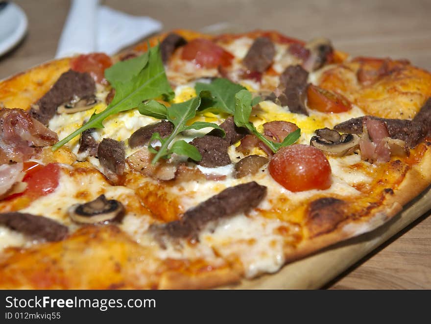 A traditional pizza on a wooden base.