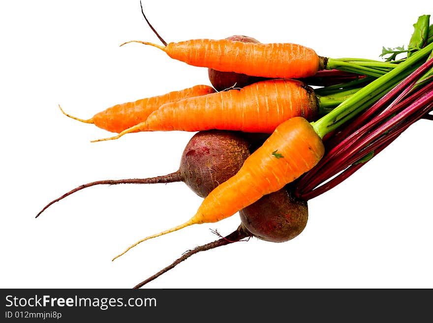 An image of fresh beets and carrots with green leaves. An image of fresh beets and carrots with green leaves