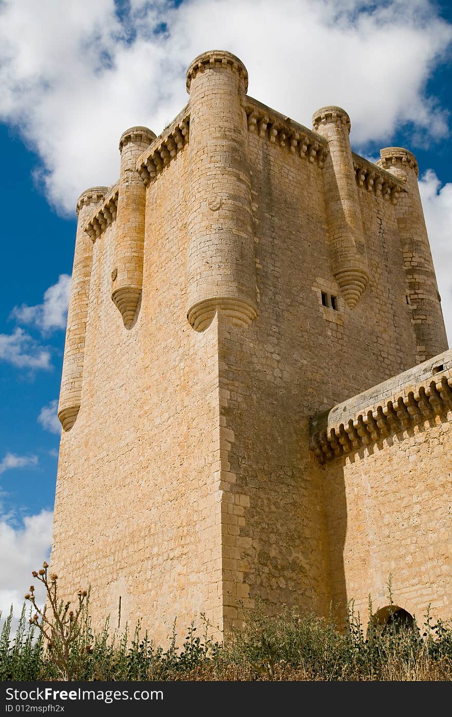 Perspective view of Torrelobaton castle main tower. It is located in a small village in Valladolid (Spain). It is over a small hill and dominates a wide plane. Most of this castles in Castilla played a fundamental role during the war between christians and muslims in the Middle Age. Perspective view of Torrelobaton castle main tower. It is located in a small village in Valladolid (Spain). It is over a small hill and dominates a wide plane. Most of this castles in Castilla played a fundamental role during the war between christians and muslims in the Middle Age.