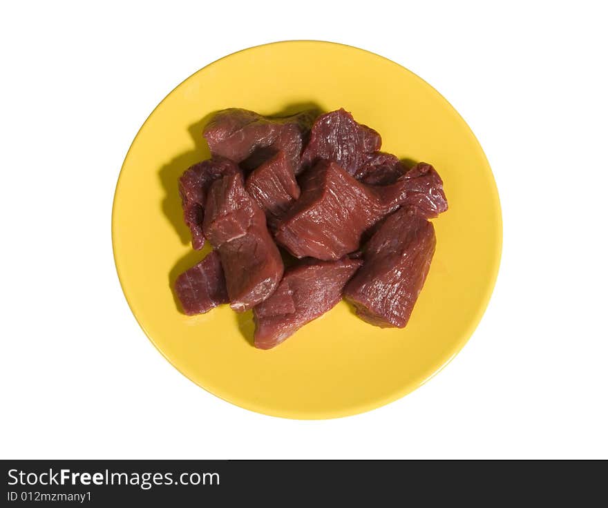 Small pieces of raw beef on yellow plate