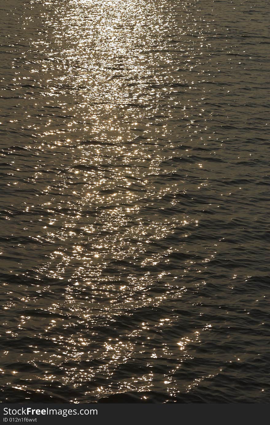 Water surface shining gold in sunlight. Water surface shining gold in sunlight.