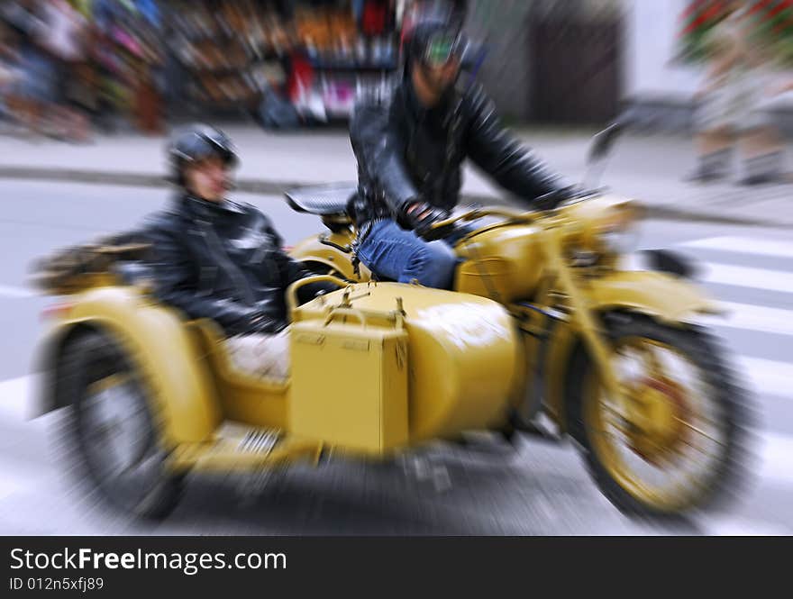 Photo of the couple riding an old motorbike