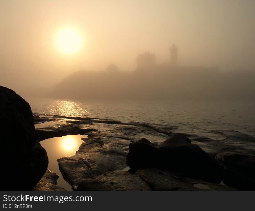 Foggy Sunrise at Lighthouse on the Ocean