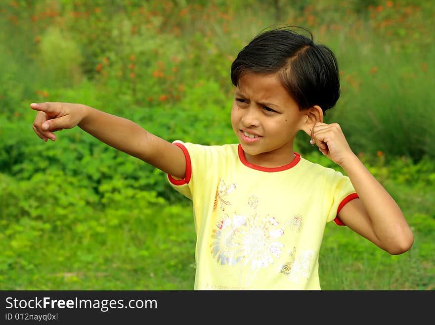 A girl pointing finger at some distant object. A girl pointing finger at some distant object.