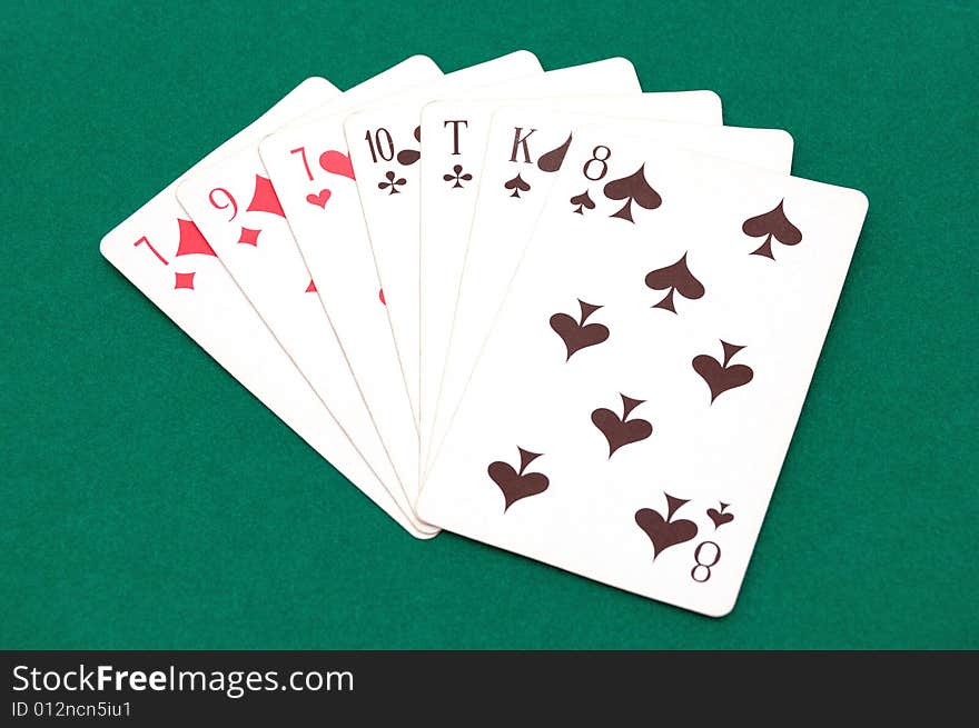 Playing cards isolated over a green background